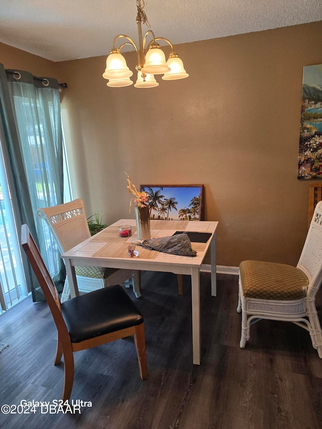 dining room with a textured ceiling, a notable chandelier, and dark hardwood / wood-style floors