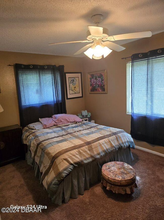 bedroom featuring carpet, a textured ceiling, and ceiling fan