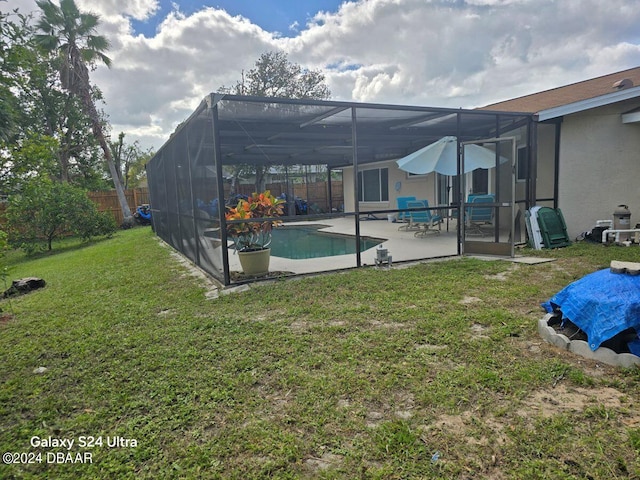 exterior space with a lanai, a patio, and a yard