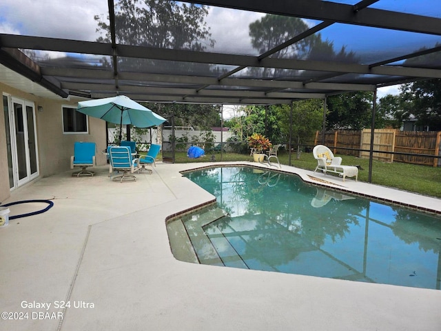 view of swimming pool with a lanai and a patio area