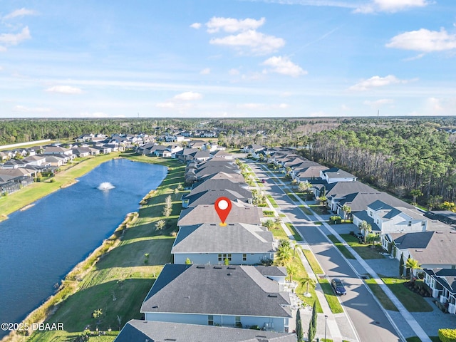 drone / aerial view featuring a residential view and a water view