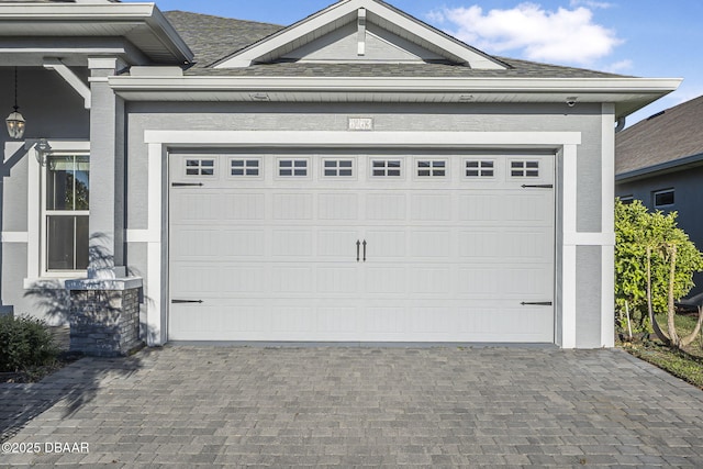 garage with decorative driveway