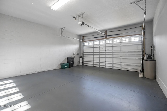 garage with concrete block wall and a garage door opener