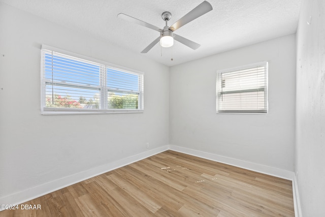 unfurnished room featuring ceiling fan, a textured ceiling, and light wood-type flooring