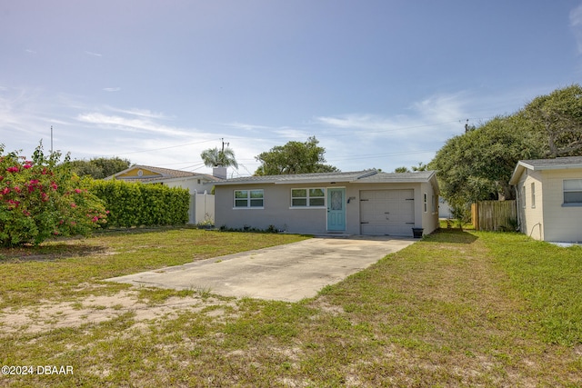 back of house featuring a garage and a lawn