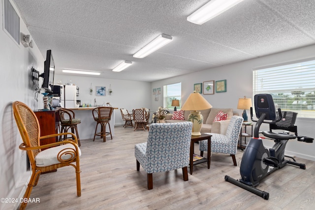 interior space featuring light hardwood / wood-style floors and a textured ceiling