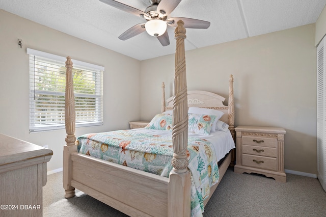 carpeted bedroom featuring ceiling fan, a textured ceiling, and a closet