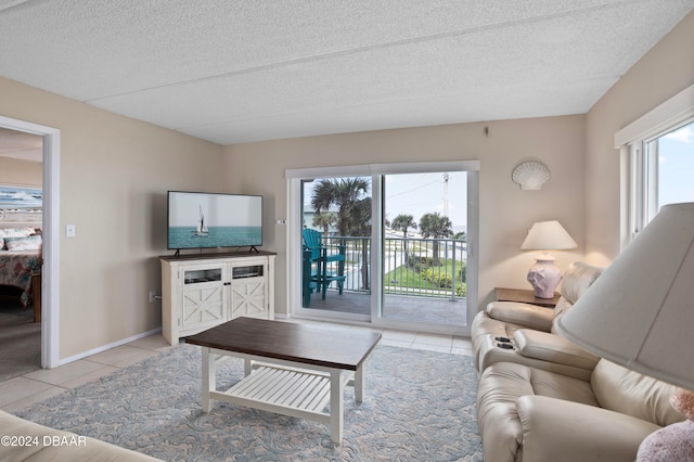 living room with light tile patterned floors and a textured ceiling