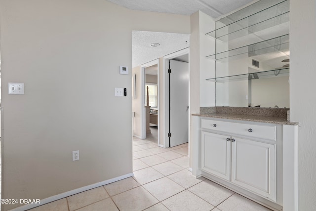 hallway with light tile patterned floors