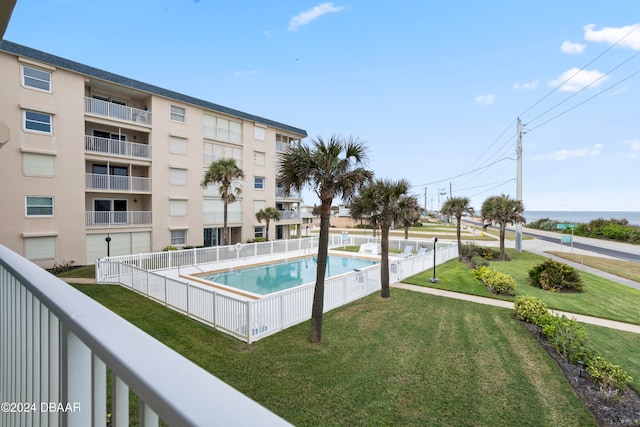 view of pool featuring a yard