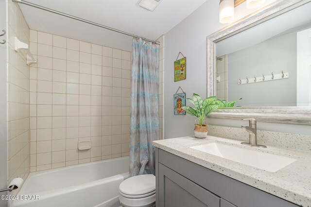 full bathroom featuring shower / tub combo with curtain, vanity, and toilet