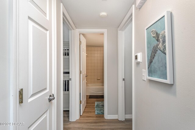 hall with hardwood / wood-style floors