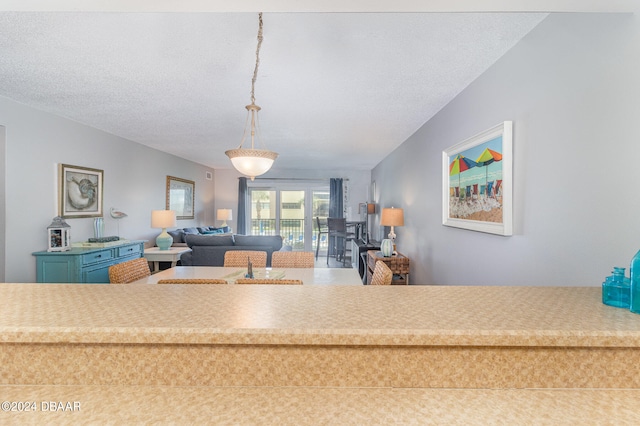 interior space featuring french doors and a textured ceiling