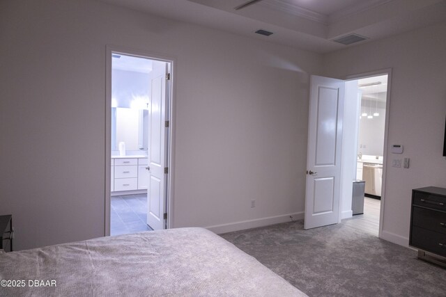 437 Aquamarine Way, Daytona Beach, FL 32124 - carpeted bedroom featuring connected bathroom, crown molding, and a raised ceiling