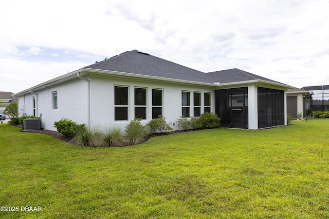 437 Aquamarine Way, Daytona Beach, FL 32124 - rear view of house featuring stucco siding, a sunroom, a lawn, and a shingled roof