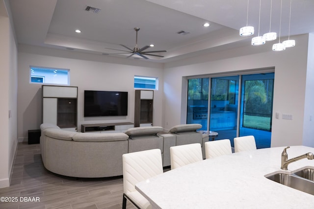 437 Aquamarine Way, Daytona Beach, FL 32124 - living area featuring a raised ceiling, light wood-style floors, ceiling fan, and recessed lighting