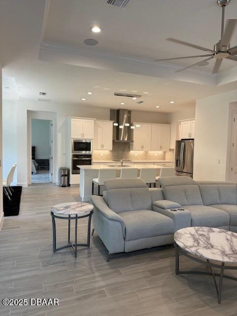 437 Aquamarine Way, Daytona Beach, FL 32124 - living room with a ceiling fan, recessed lighting, a raised ceiling, and ornamental molding