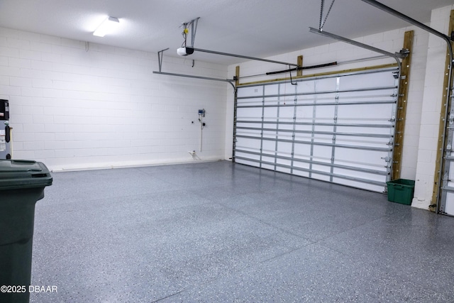 437 Aquamarine Way, Daytona Beach, FL 32124 - garage featuring a garage door opener and concrete block wall