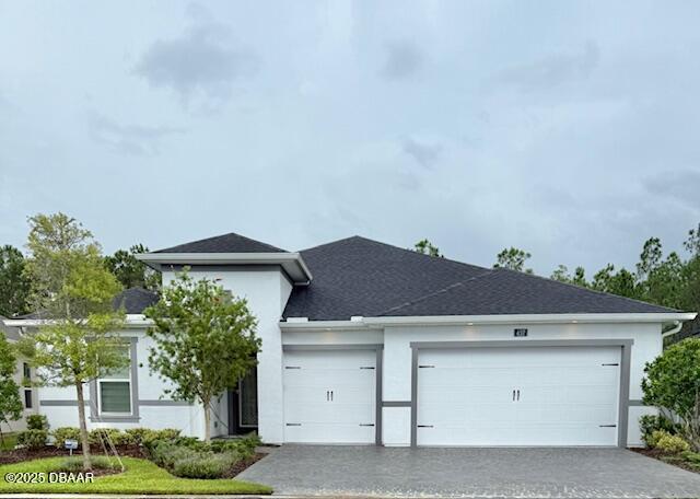 437 Aquamarine Way, Daytona Beach, FL 32124 - view of front of home with an attached garage, driveway, and stucco siding