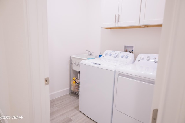 437 Aquamarine Way, Daytona Beach, FL 32124 - washroom with washer and dryer, cabinet space, and light wood-style floors