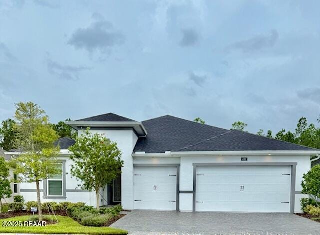 437 Aquamarine Way, Daytona Beach, FL 32124 - view of front facade featuring decorative driveway, a garage, stucco siding, and roof with shingles