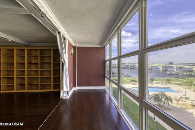 unfurnished sunroom with a water view