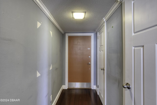 hall featuring a textured ceiling and dark hardwood / wood-style floors