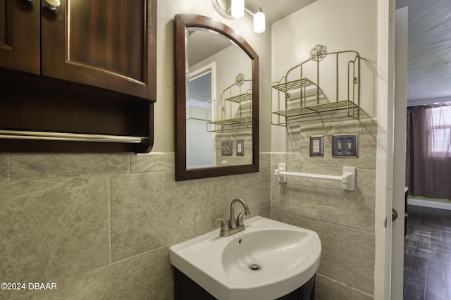 bathroom featuring tile walls and sink