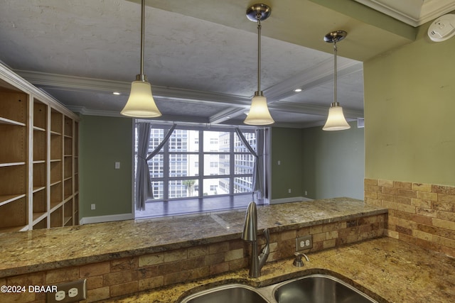 kitchen featuring beamed ceiling, decorative light fixtures, ornamental molding, and sink