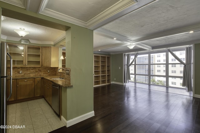 kitchen with a wealth of natural light, sink, dishwasher, and hardwood / wood-style floors