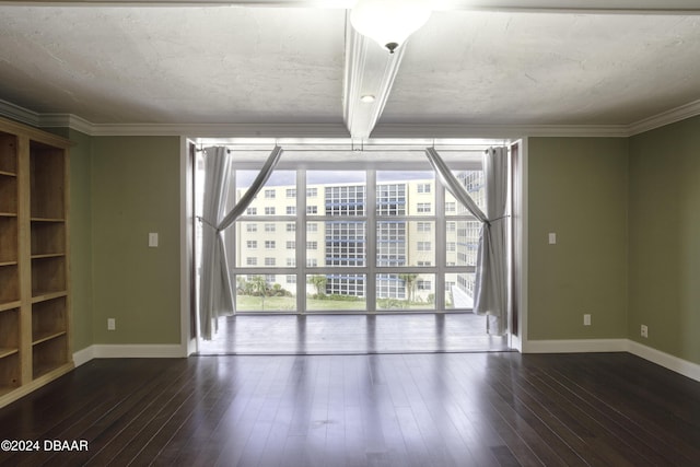 empty room with crown molding and dark wood-type flooring