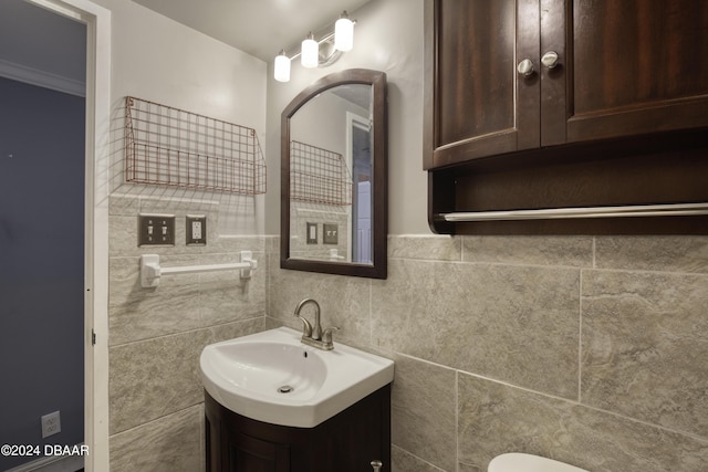 bathroom with vanity and tile walls