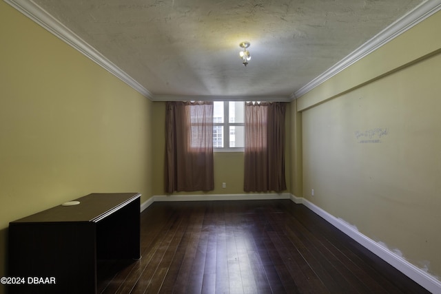 spare room featuring crown molding and dark hardwood / wood-style floors