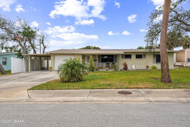 single story home featuring a garage, a front yard, and a carport