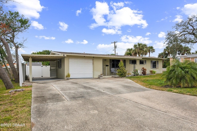 ranch-style home with a carport, a garage, and a front lawn