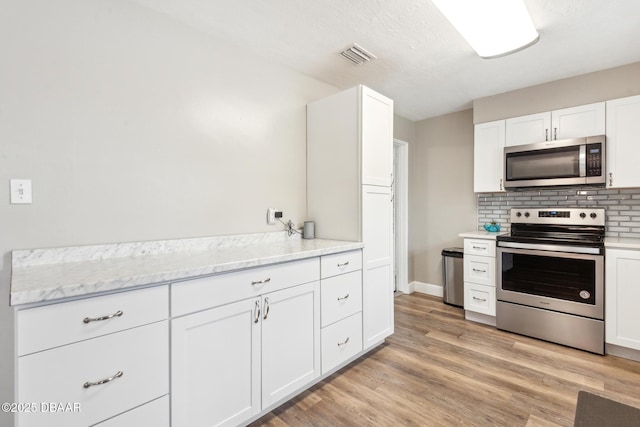 kitchen featuring appliances with stainless steel finishes and white cabinets