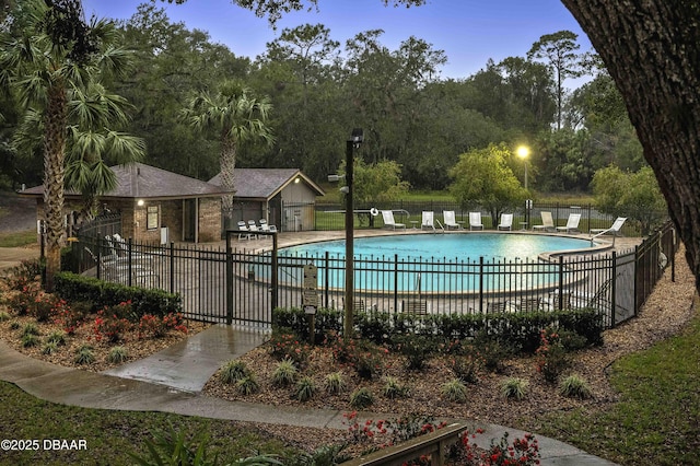 pool at dusk with a patio