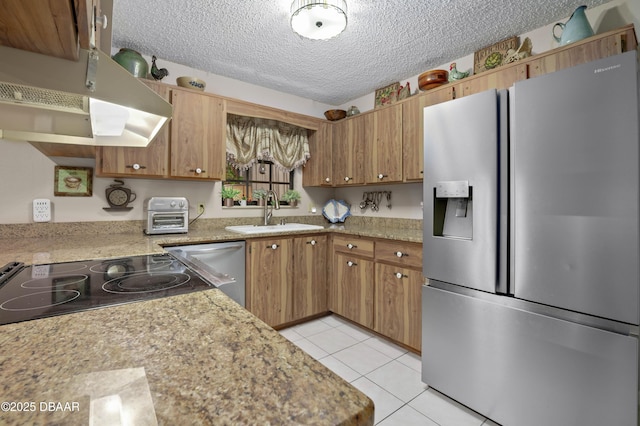 kitchen with a textured ceiling, stainless steel appliances, sink, light tile patterned floors, and range hood