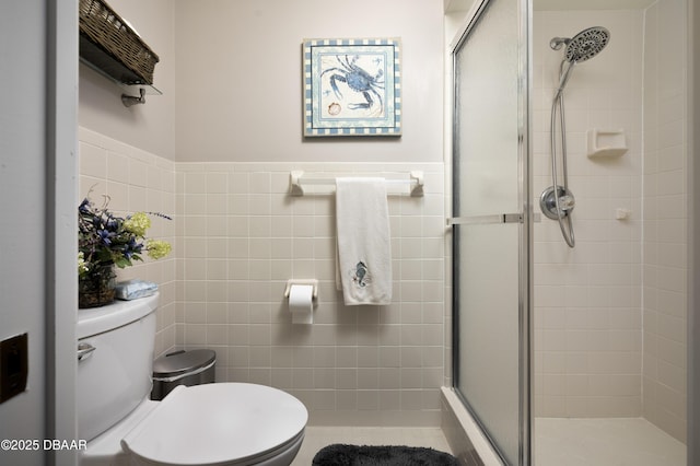 bathroom featuring toilet, tile walls, and walk in shower