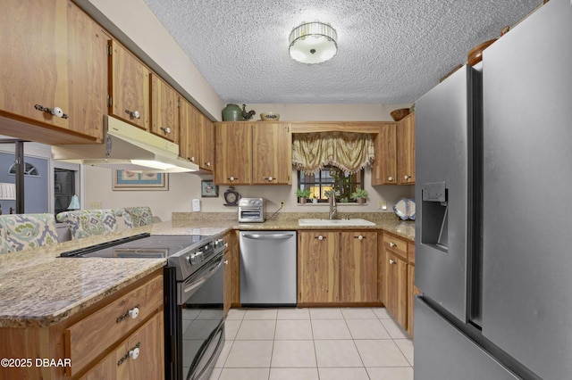 kitchen with kitchen peninsula, appliances with stainless steel finishes, a textured ceiling, sink, and light tile patterned flooring