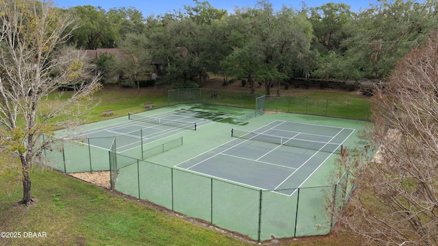 view of tennis court with a yard