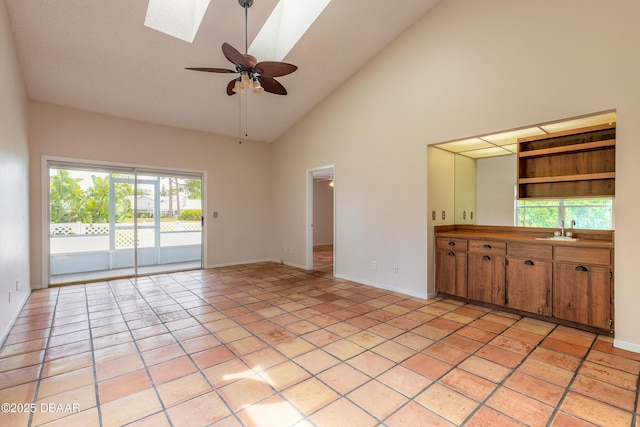 936 Meadow View Dr Unit A, Port Orange, FL 32127 - unfurnished living room with a skylight, high vaulted ceiling, a sink, baseboards, and ceiling fan