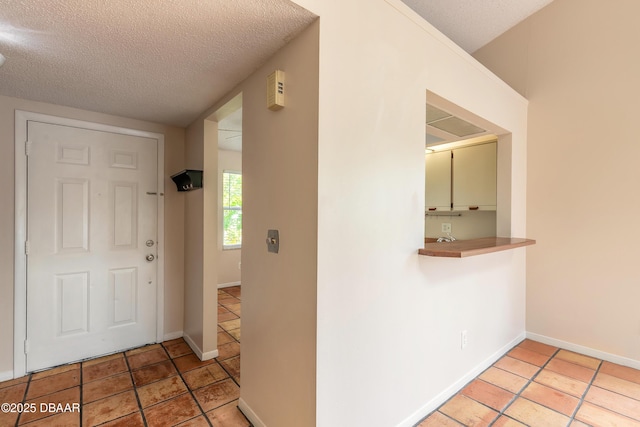 936 Meadow View Dr Unit A, Port Orange, FL 32127 - foyer with a textured ceiling, light tile patterned floors, and baseboards