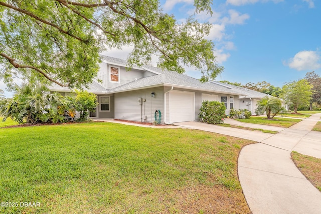 936 Meadow View Dr Unit A, Port Orange, FL 32127 - view of front of house with driveway, an attached garage, a front lawn, and roof with shingles