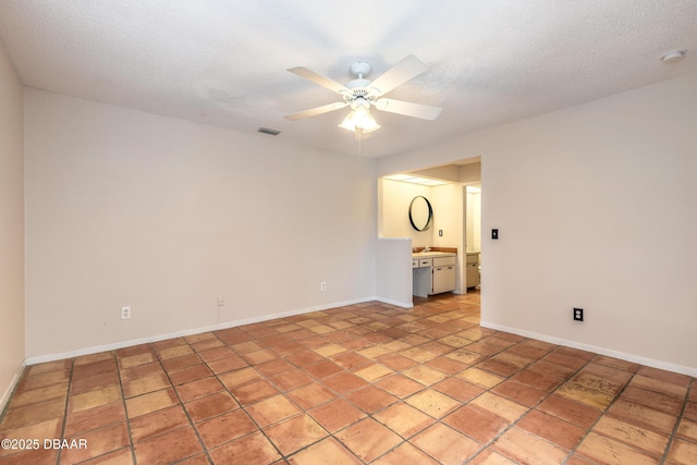 936 Meadow View Dr Unit A, Port Orange, FL 32127 - empty room with a ceiling fan, baseboards, a textured ceiling, a sink, and a smoke detector