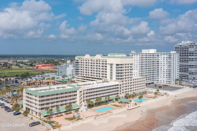 drone / aerial view featuring a water view and a view of the beach