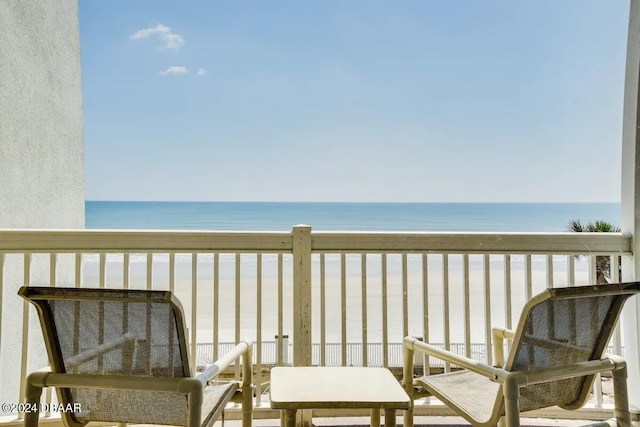 balcony with a view of the beach and a water view