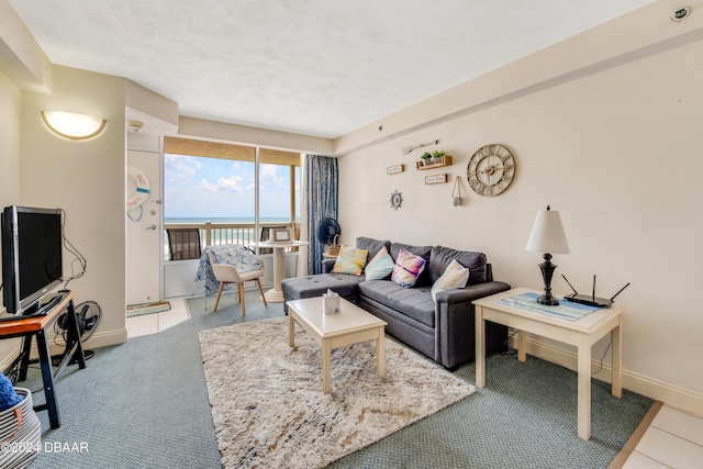 living room with light carpet and a water view