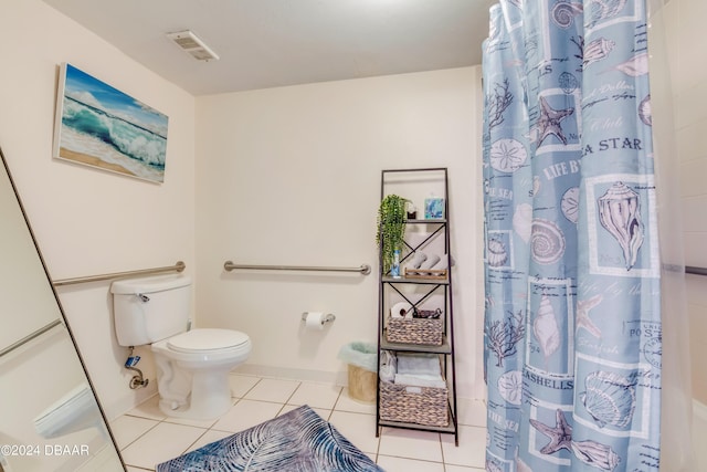 bathroom featuring tile patterned floors, a shower with curtain, and toilet