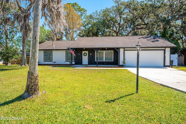 single story home with an attached garage, a front lawn, and concrete driveway